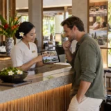 Hotel team member presenting personalised experiences to a guest after booking